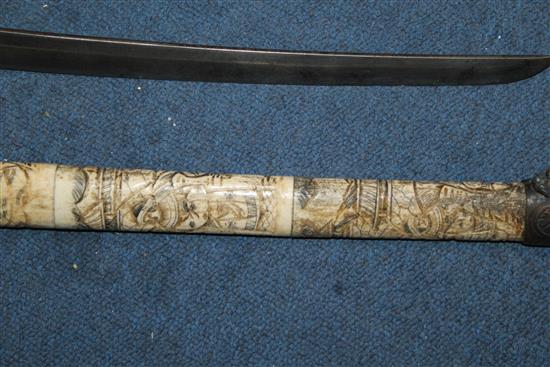 An early 20th century Japanese bone wakizashi and another